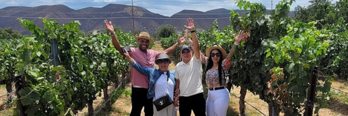 A group of friends enjoying wine at a vineyard in Palisade, CO